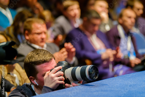 Professional photographer works at business conference photo