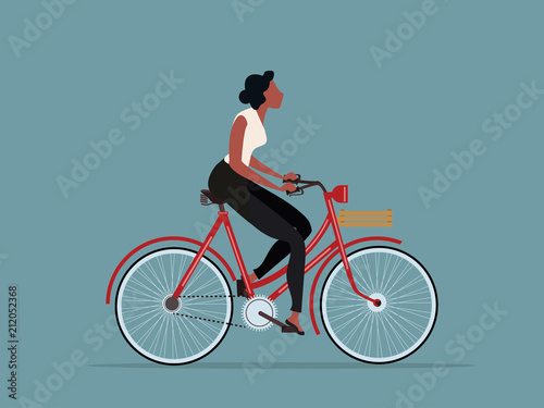 Fototapeta Naklejka Na Ścianę i Meble -  vintage style woman riding a bicycle