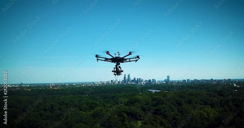 Drone takes off and raises its' skids with Philadelphia's skyline visible in the background. Drone takes off and raises its' skids with Philadelphia's skyline visible in the background.