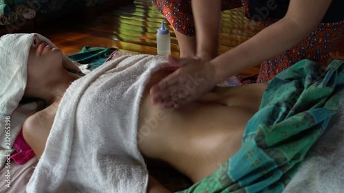 Thai massage of the abdomen of a woman photo