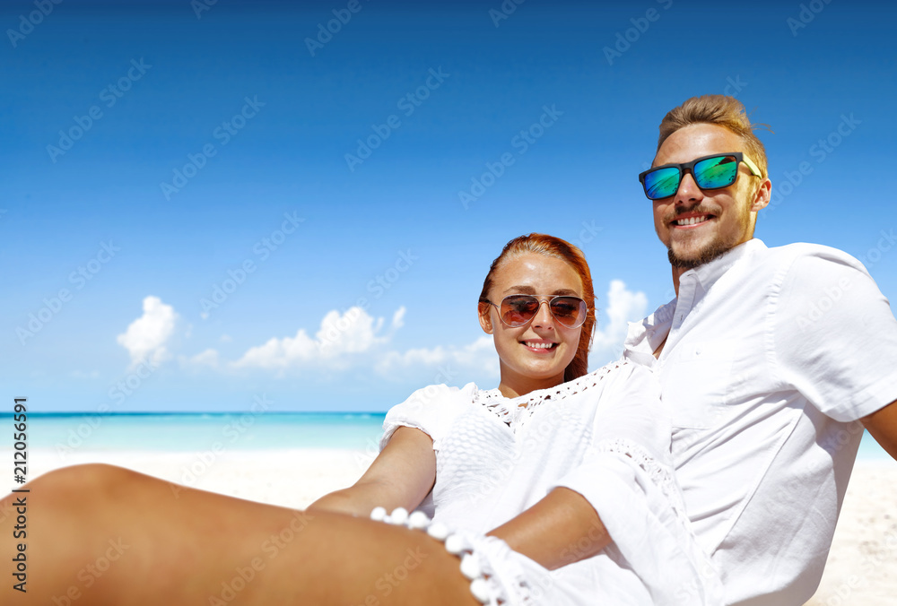 Summer trip on beach. Two lovers and sea landscape with blue sky. Free space for your text. Summer trip on beach. Two lovers and sea landscape with blue sky. Free space for your text.