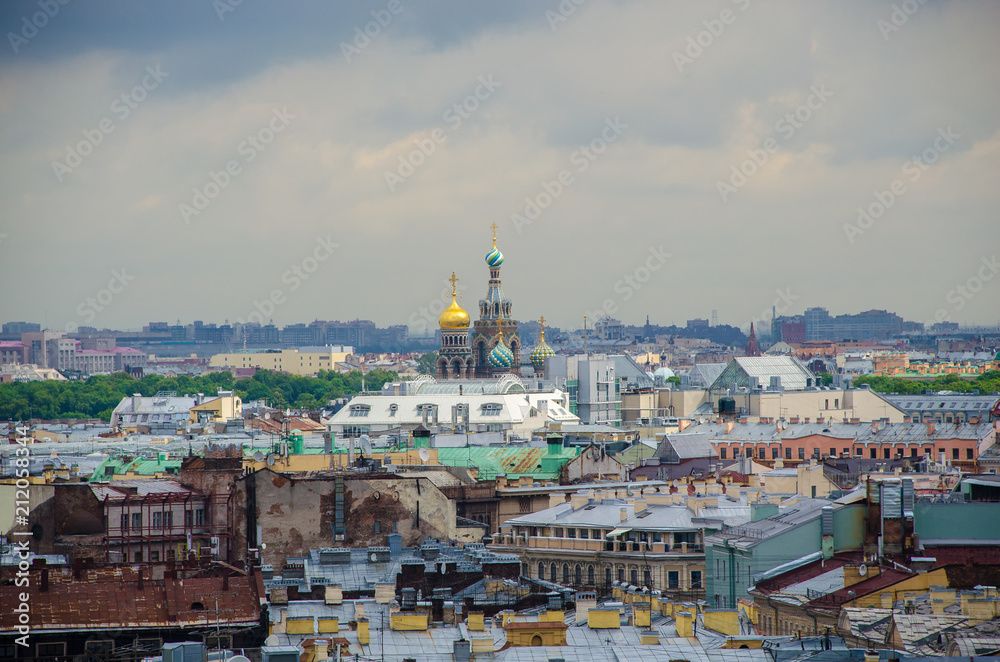 Domes of the Church of the Savior on Blood above the roofs of houses in St. Petersburg
