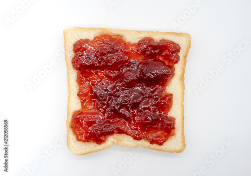 homemade slide bread with strawberry jam isolated on white
