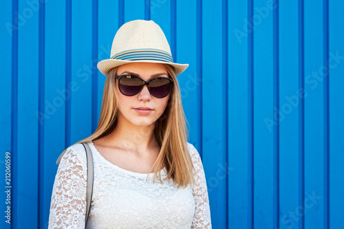 Young hipster girl over blue background