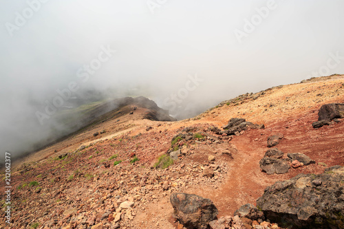 Red earth and volcanic rocks on Mt. Asahi in Hokkaido, Japan