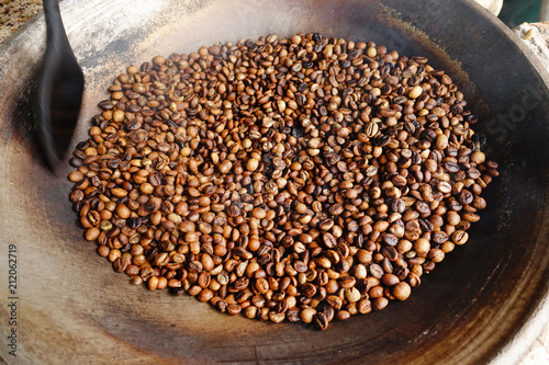 Coffee beans are roasting in pan. Traditional techniques. © nimon_t