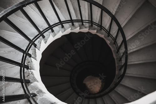 View to the circle spiral staircase in old building, black and white