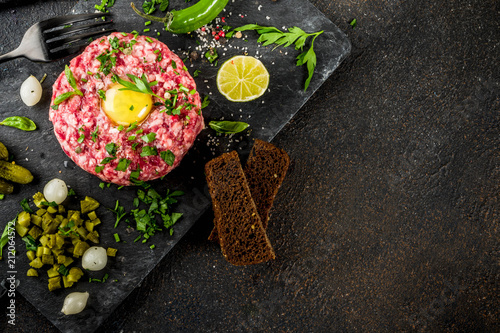 Tablou pe pânză French cuisine, beef steak tartare with raw quail egg yolk, pickled cucumber and