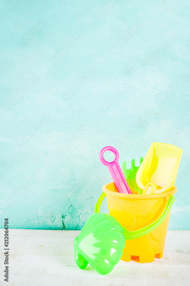 Summer vacation concept with plastic blue boat, lifebuoy and bright sand's toys, copy space Summer vacation concept with plastic blue boat, lifebuoy and bright sand's toys, copy space
