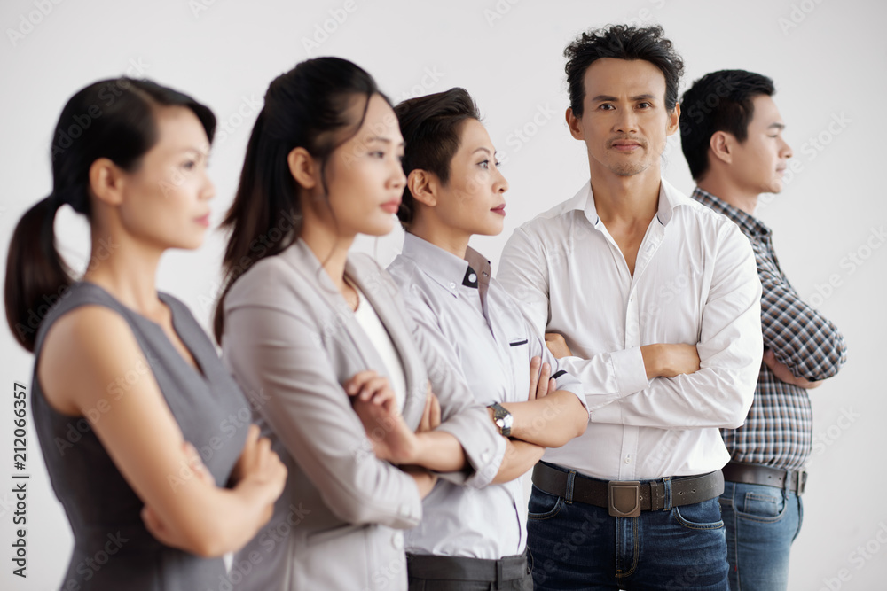 Portrait of confident businessman standing with his team on white background Portrait of confident businessman standing with his team on white background