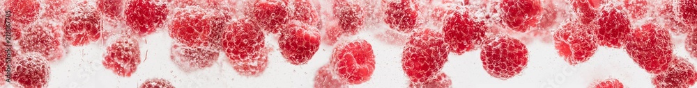 Fresh raspberries in water wiht air bubbles.