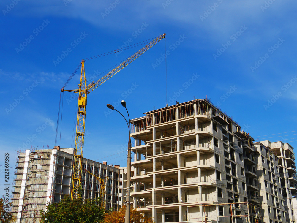 Crane near building. Building under construction. Construction site. Crane near building. Building under construction. Construction site.