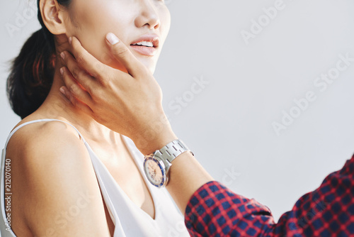 Crop man touching cheek of sensual beautiful woman with love and tenderness on white background