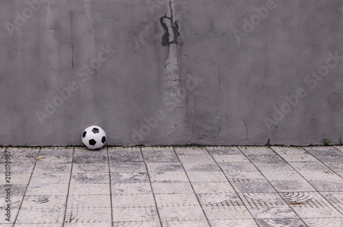 classic soccer ball near the gray wall