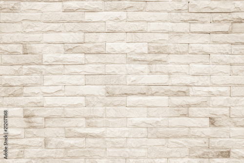 Cream and white brick wall texture background. Brickwork or stonework flooring interior rock old pattern clean concrete grid uneven bricks design stack.