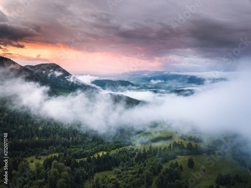 Dramatic sunset,foggy forest landscape captured from above with drone.Location Carpathian Mountains,Romania.