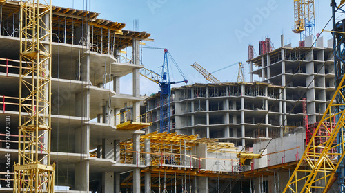Construction site background. Hoisting cranes and new multi-storey buildings. I.ndustrial background.