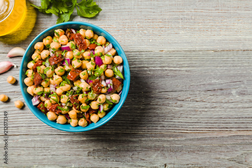 Chickpeas salad with onion and dried tomatoes. photo