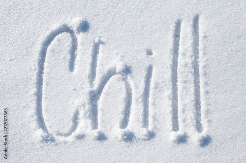 Chill. Hand drawn text over white snow