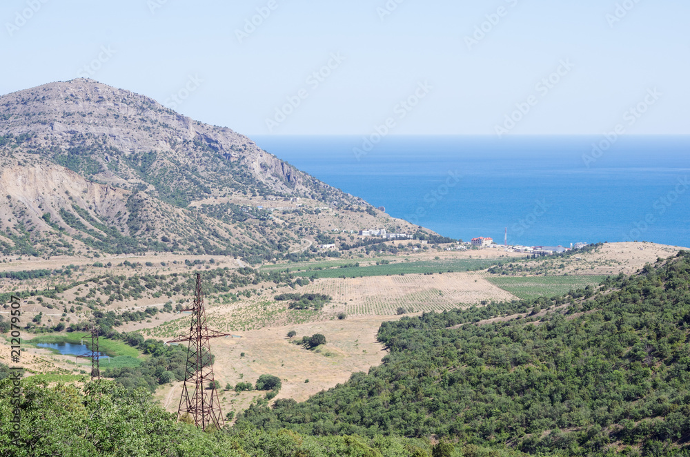 Russia, the Republic of Crimea, Sudak city district, Vesyoloe village. 06/08/2018: View of the village on the shore of the Black Sea