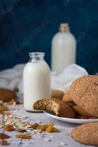 Healthy Breakfast with Oatmeal Cookies  Raisins  Oatmeal and Milk on a Dark Blue Background. Concept Healthy Eating