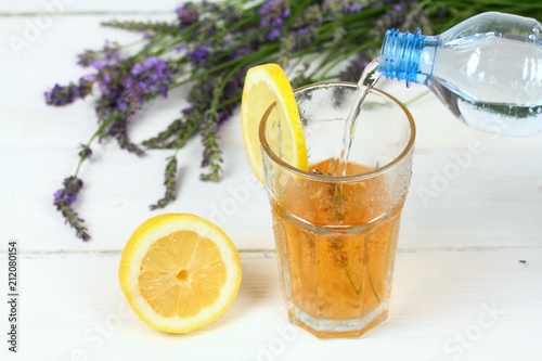 Making homemade lemonade / Pouring soda water into lavender syrup. Made from fresh aromatic lavender flowers, sugar or honey and lemon juice