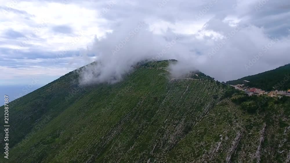 Aerial. Mountains in clouds at Llogara Pass, Llogara National Park, Albania. Footage near sea cost and high rocks in Albania summer. Aerial. Mountains in clouds at Llogara Pass, Llogara National Park, Albania. Footage near sea cost and high rocks in Albania summer.