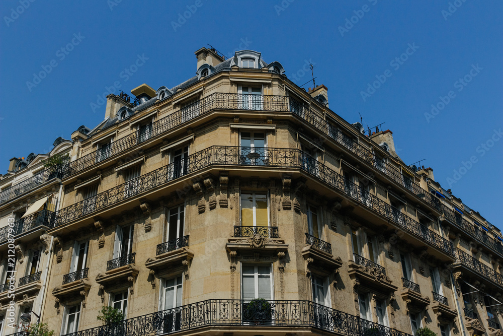 Paris residential buildings. Old Paris architecture, beautiful facades, typical french houses on sunny day. Famous travel destinations in Europe. City life, lifestyle and expensive real estate concept