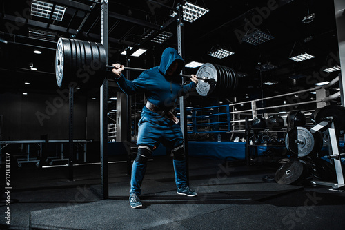 Strong man working in gym photo