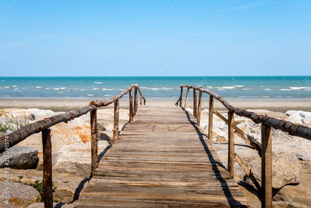 Wooden bridge walkway to the sea beach