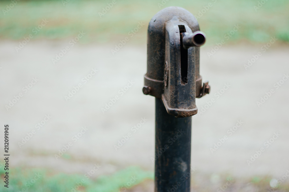 Iron column for water. Rusted iron. Column background in natural environment Iron column for water. Rusted iron. Column background in natural environment