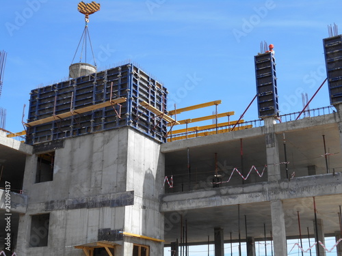 Workers at the construction site, building high-rise buildings.