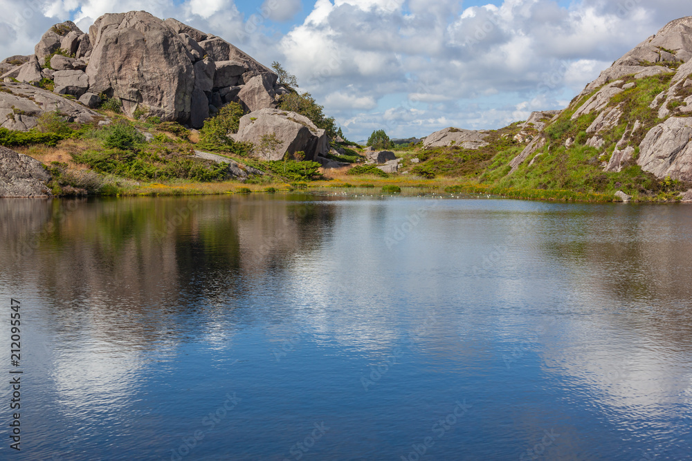 Mountain lake with water lilies in Egersund, Jaeren national scenic route in western Norway