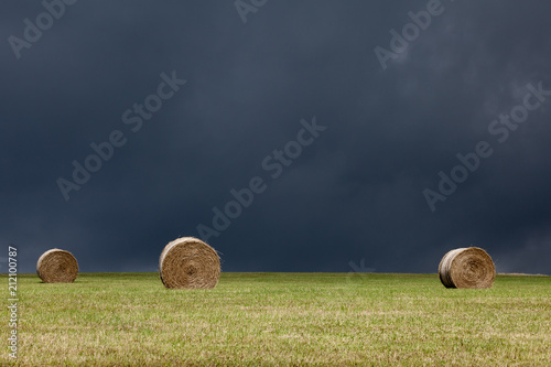 agriculture,bale,blue,country,countryside,dark,farm,farming,farmland,field,grass,harvest,hay,landscape,meadow,nature,rural,sky,straw,summer