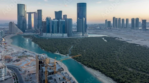 Buildings on Al Reem island in Abu Dhabi day to night timelapse from above. photo