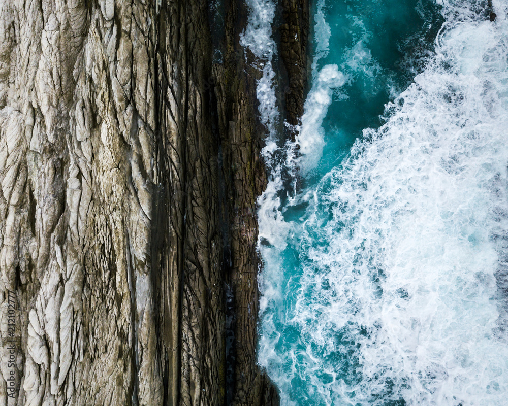 Aqua waves meet textured rocks Aqua waves meet textured rocks