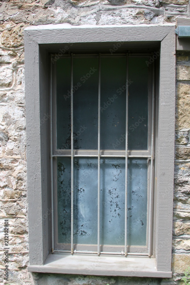 A window frame on the building and on a close view.