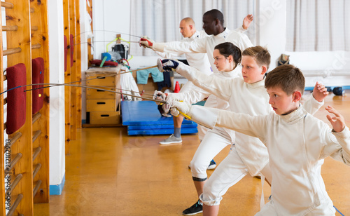 fencers athletes of different ages on training