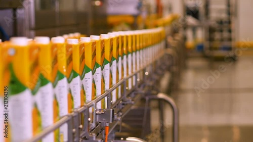 Packaging with juice on the conveyer tape