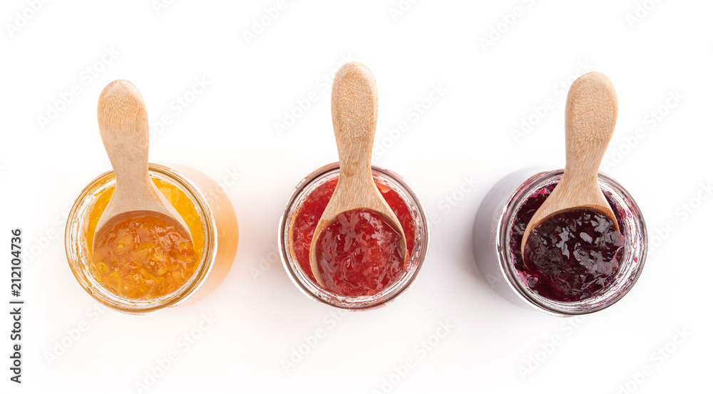 Open jar of strawberry, orange and blueberries jam and a spoon, isolated on white, top view. Open jar of strawberry, orange and blueberries jam and a spoon, isolated on white, top view.