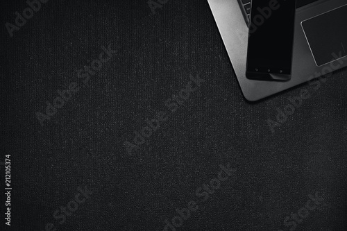 Top view smartphone with laptop keyboard on black background, Technology