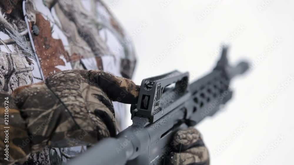 Close-up view of tactical gun. Man's hand hold a gun and show sighting tools Close-up view of tactical gun. Man's hand hold a gun and show sighting tools