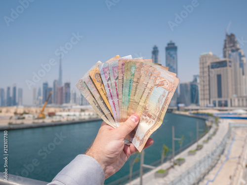 Photography A man holds the money of the United Arab Emirates. Dirham.