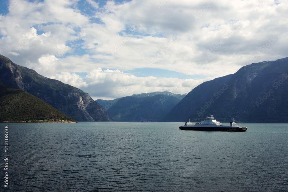 Ferry ship crosses the sea in the fjord in Norway