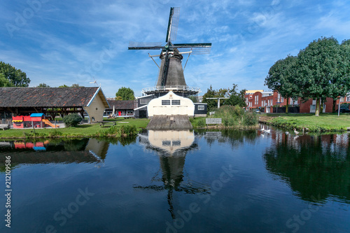 Windmill and mirrored in the water in front