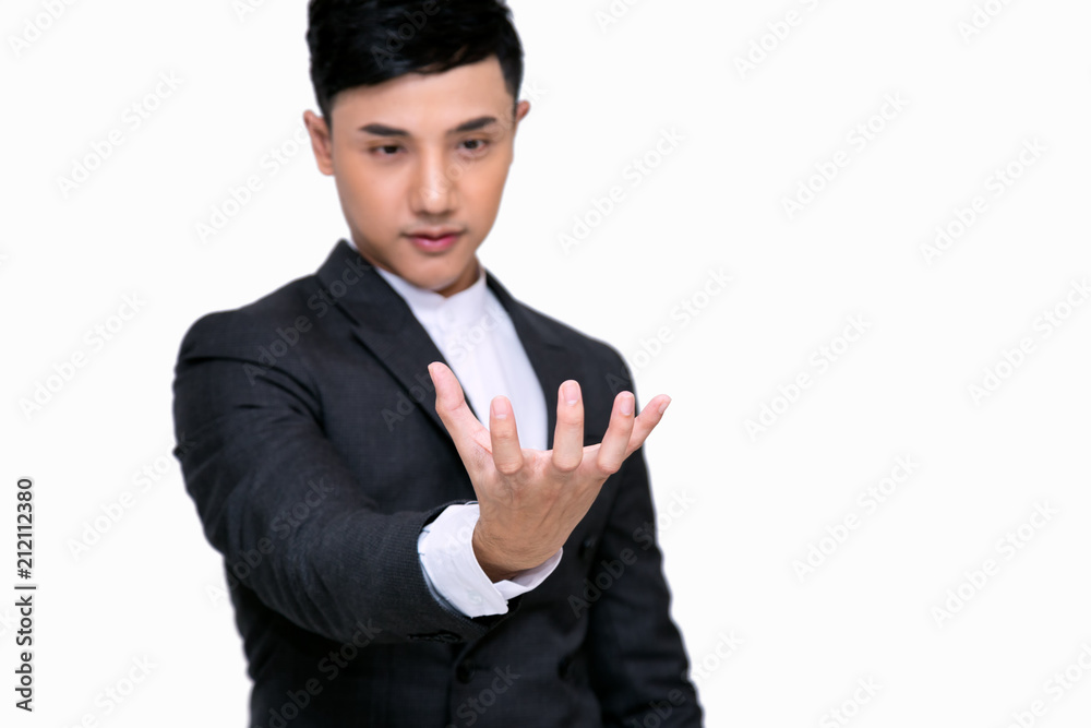 Young businessman holding some thing in his hand;.Standing on white background with clipping path Young businessman holding some thing in his hand;.Standing on white background with clipping path