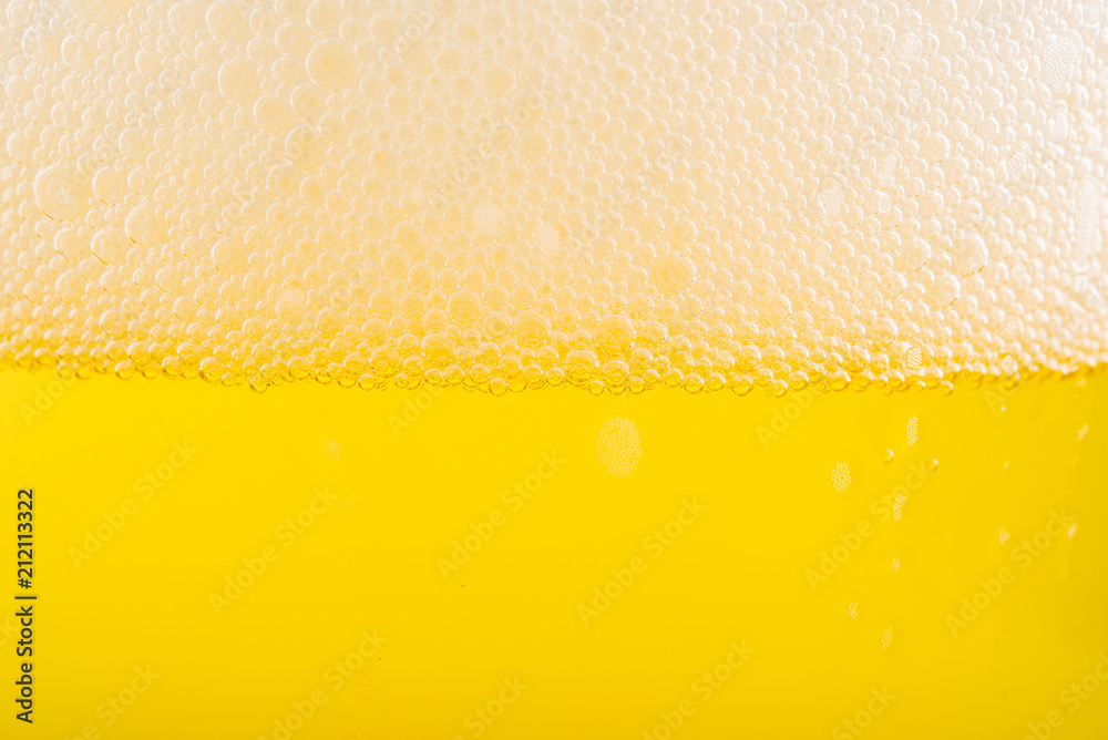 Pouring beer with bubble froth in glass for background. Pouring beer with bubble froth in glass for background.