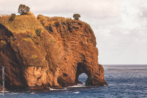 Sea shore cliff with natural arch