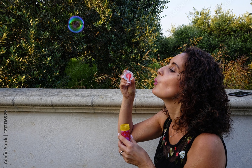 woman makes soap bubbles