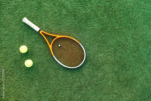 Tennis ball and rackets on grass